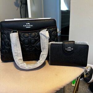 Brand new never used black monogram Coach purse and matching wallet